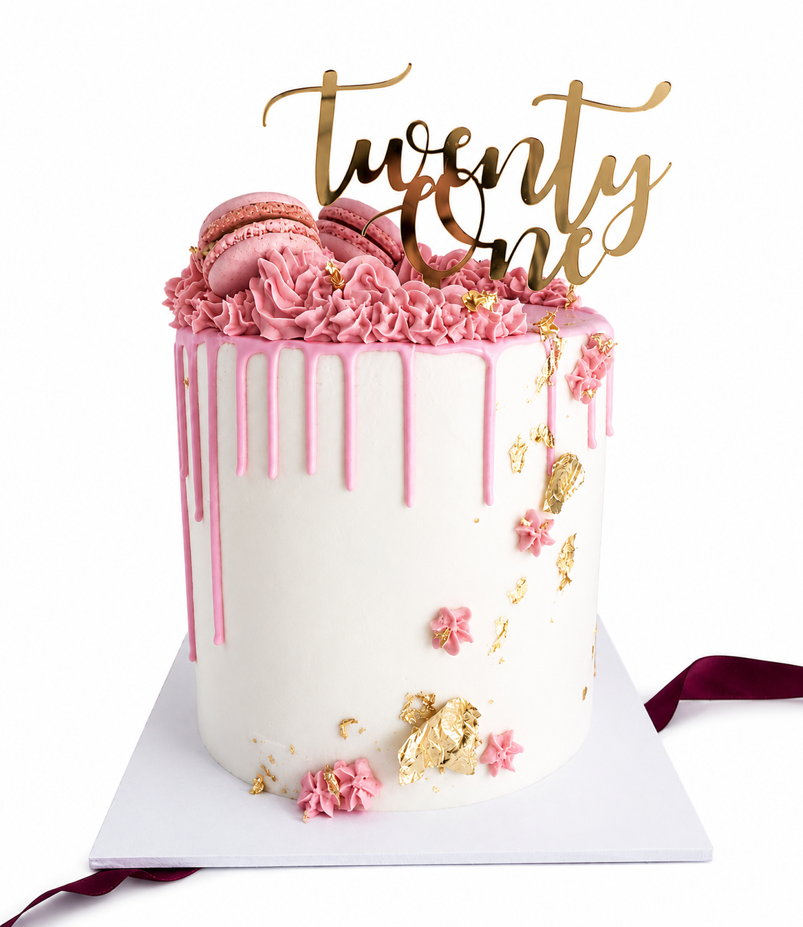 White and pink 21st birthday cake with a gold acrylic topper and edible gold leaf