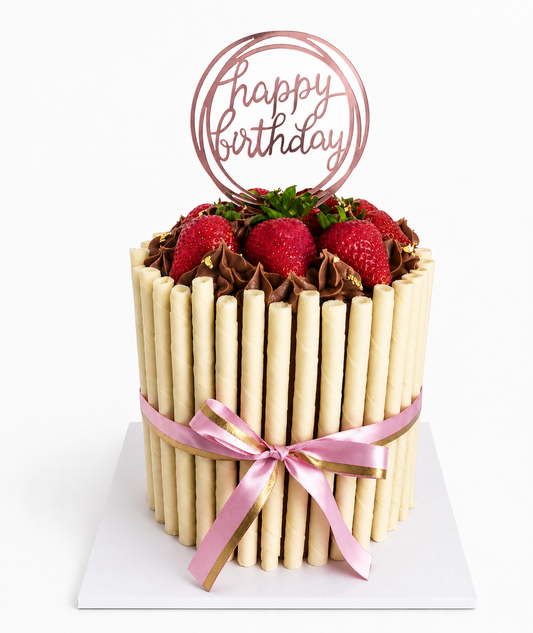 Chocolate cake wrapped in wafer sticks and topped with fresh strawberries