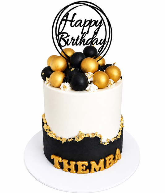 Black and white fault line cake with edible gold leaf and a black acrylic topper