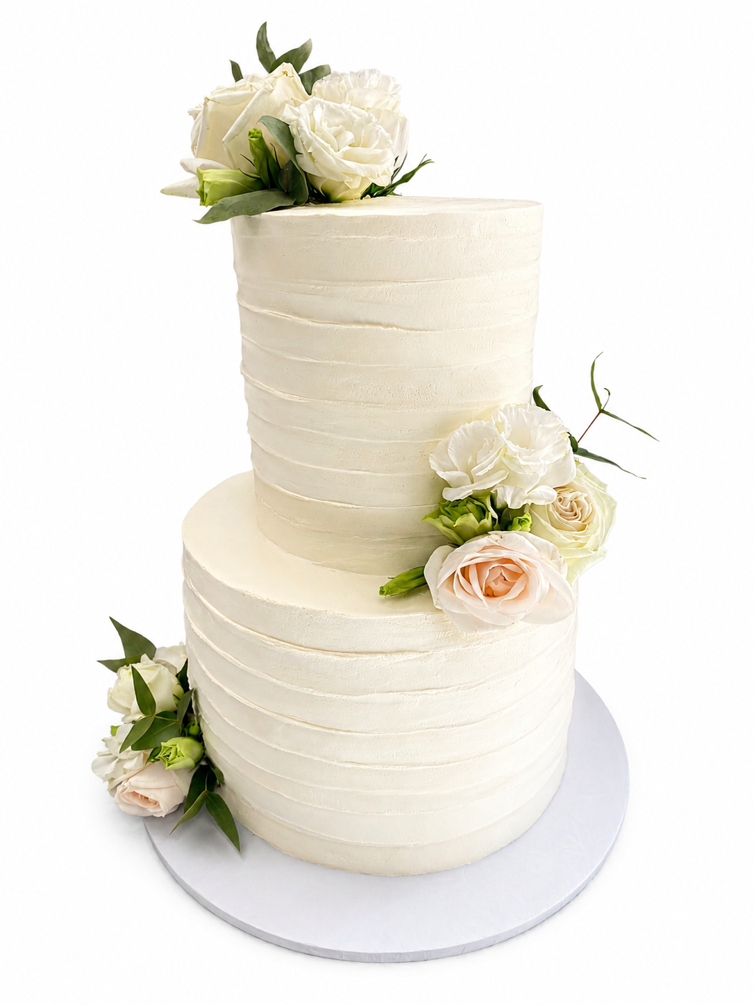 White textured wedding cake decorated with fresh blooms