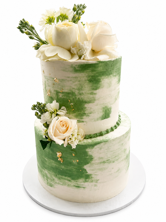Two tier sage green and white wedding cake with edible gold and fresh flowers