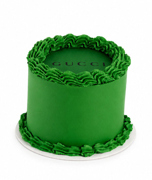 Birthday cake decorated in a designer inspired stripe pattern with gold detail